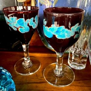 A pair hand blown goblets or wine glasses.  Bottoms are Stamped with flower